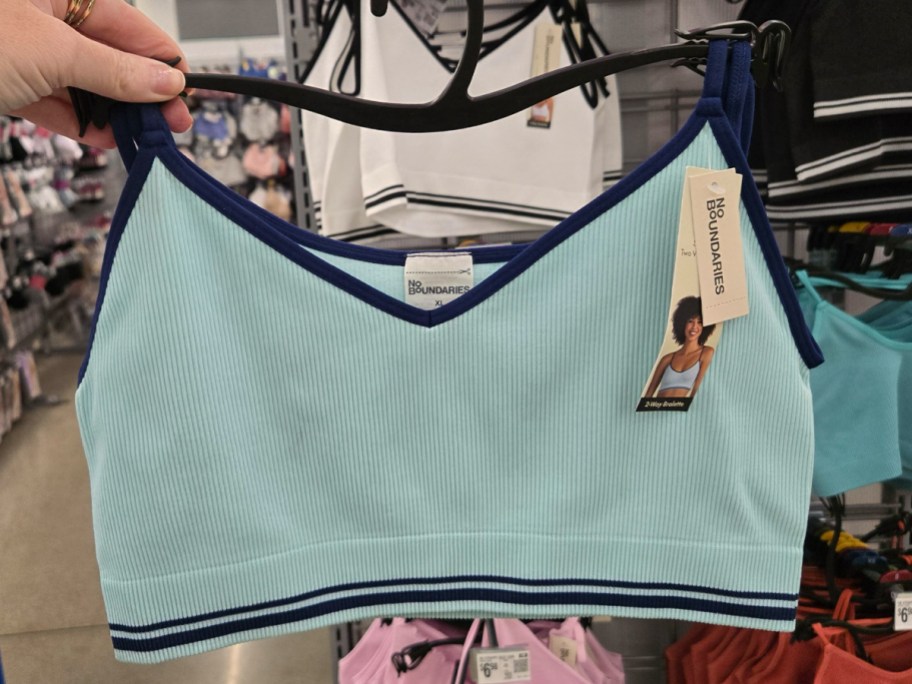 No Boundaries 2-Way Bralette in blue being held in Walmart aisle