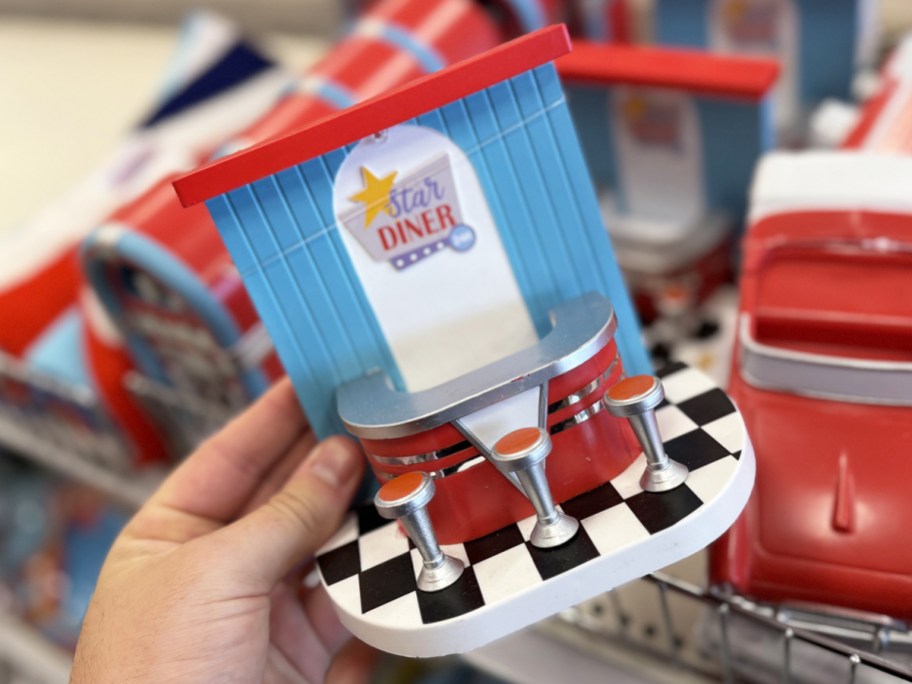 hand holding a retro diner figurine