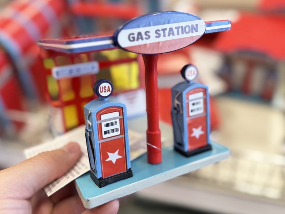 holding a retro gas station figurine