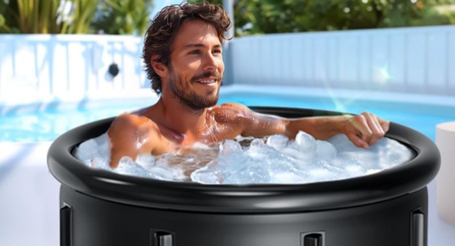 man taking an ice bath in his backyard with a potable pool 