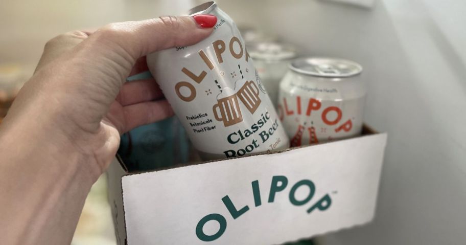 hand taking an olipop can from case