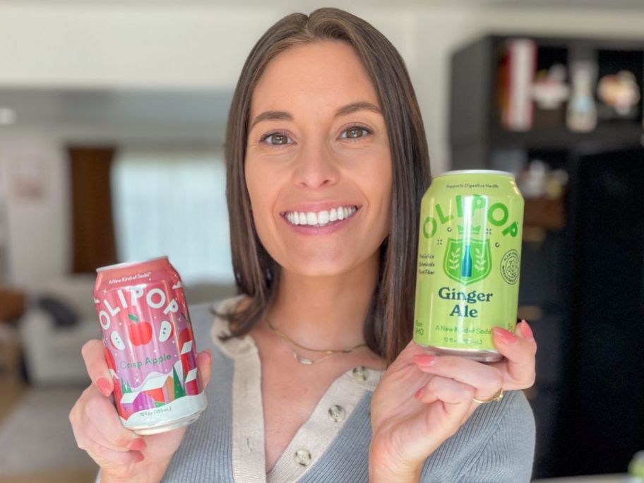 Woman hlding two cans of Olipop