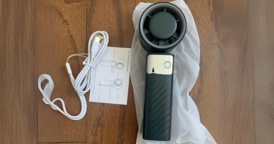 portable turbo fan in black with packaging and charging cord