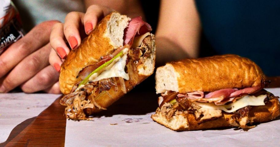 a womans hand holding a Potbelly cubano sandwich