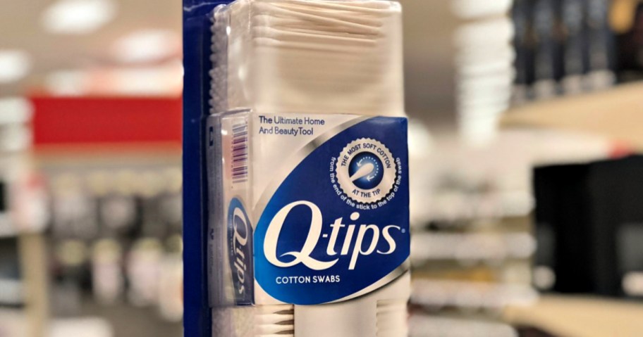 Q-Tips Cotton Swabs in hand at store