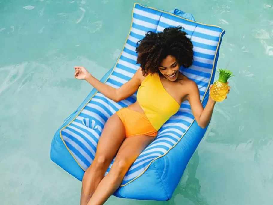 Woman sitting in a Big Joe Captain's Chair Pool float in a pool