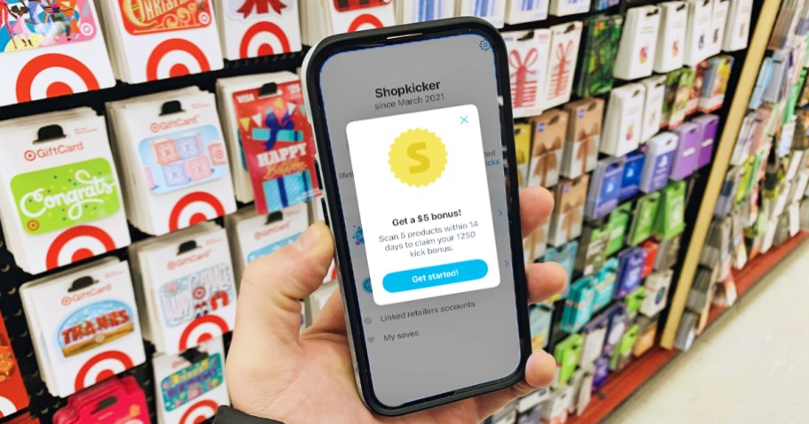 hand holding a phone displaying shopkick app in store