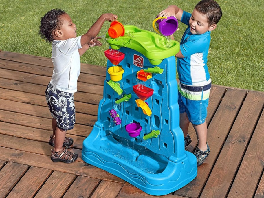 toddler boys playing with Step2 Waterfall Discovery Wall