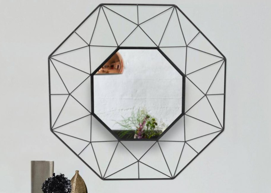 black octagon shaped mirror on wall