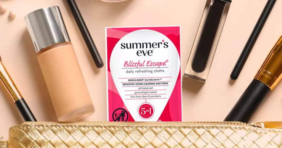 Summers eve blissful escapes cleansing cloth sticking out the top of a gold makeup bag