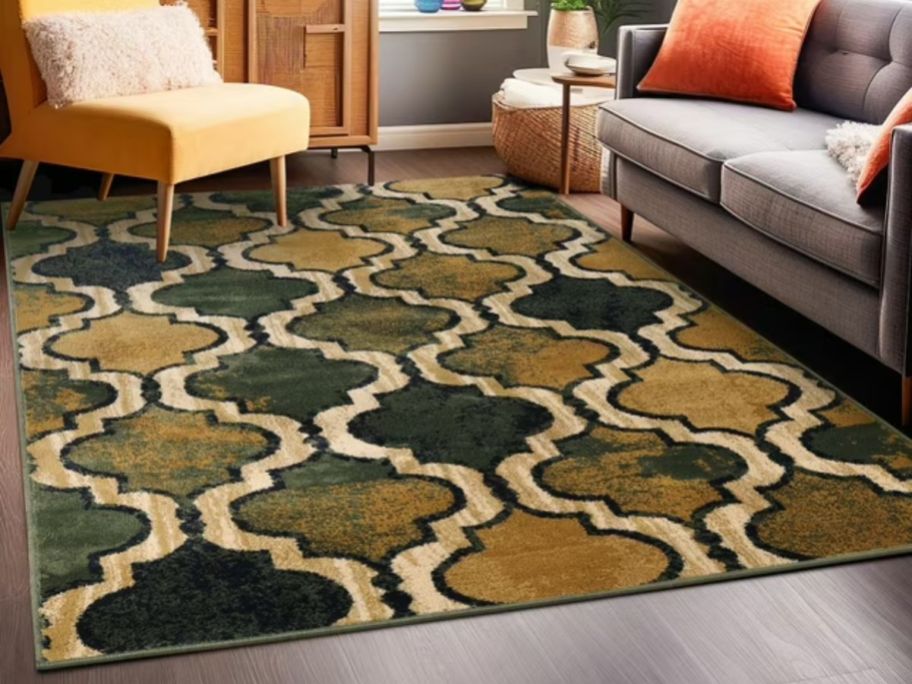 A green and tan area rug in a living room 