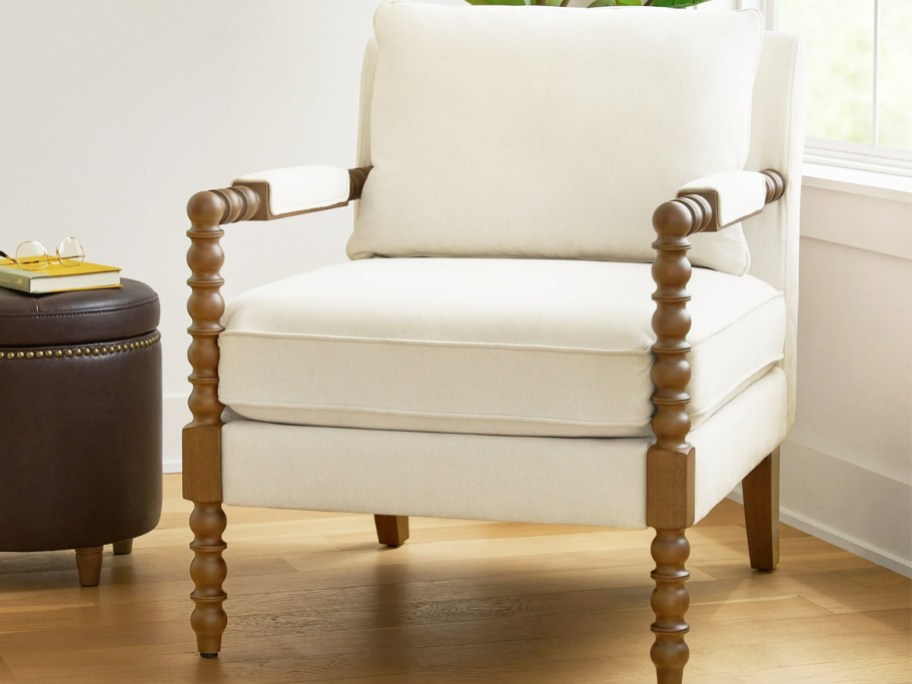 white upholstered accent chair with wood spindle arms and legs