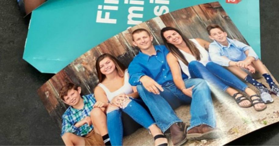 photo print of a family leaning against a barn