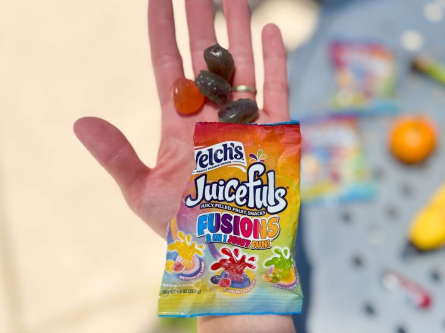 A person holding a Welch's Juicefuls Fruit Snack packet