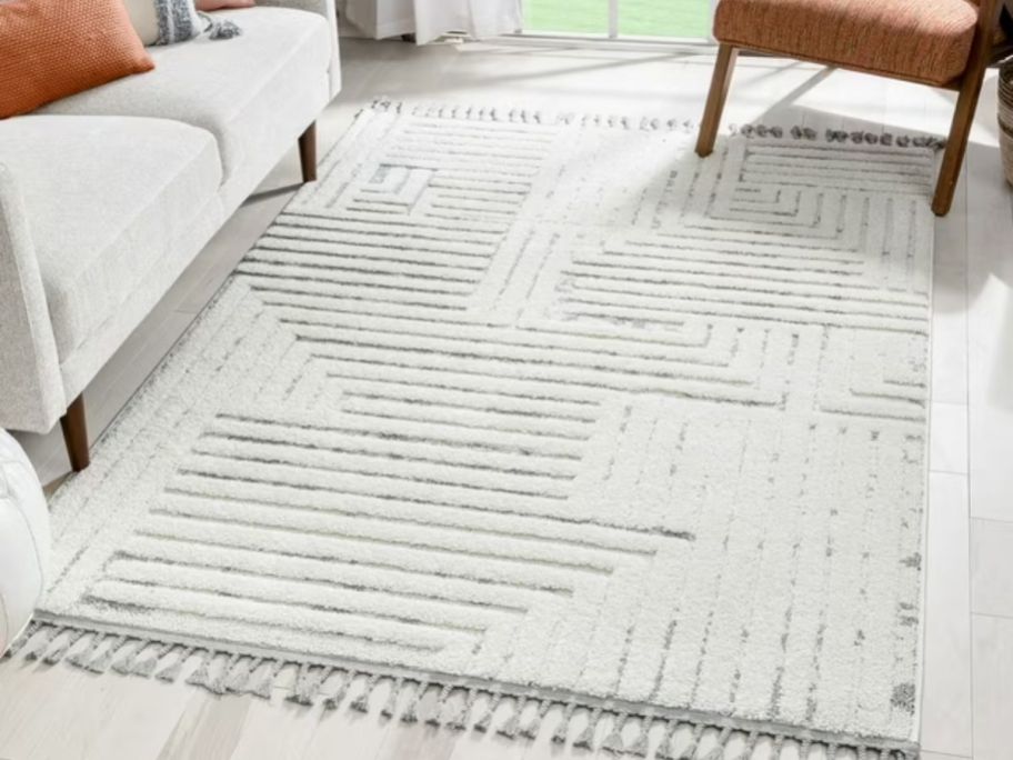 A light-colored geometric rug on a living room 
