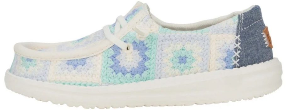 a white sneaker with granny square crocheted upper