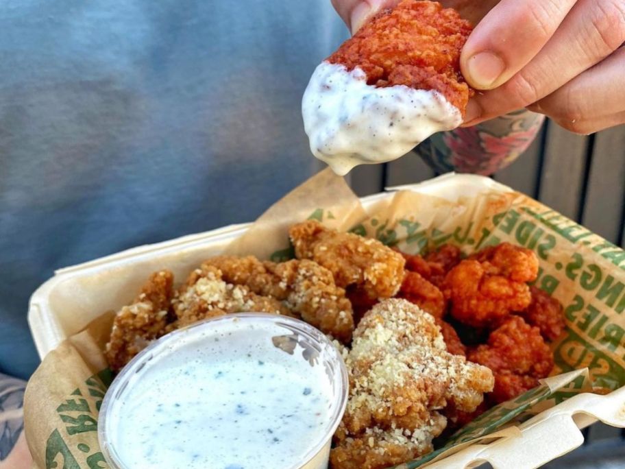 A takeout container filled with Wingstop Boneless Wings