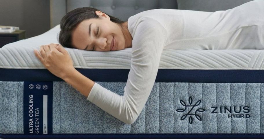 Woman laying on a Zinus Green Tea Cooling Mattress with her eyes closed