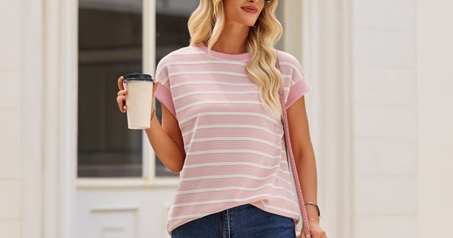 Women's Cap Sleeve Crewneck Top being worn by a lady walking down the street holding a coffee