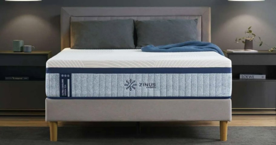 memory foam mattress with pillows on top of a grey bed frame with matching headboard