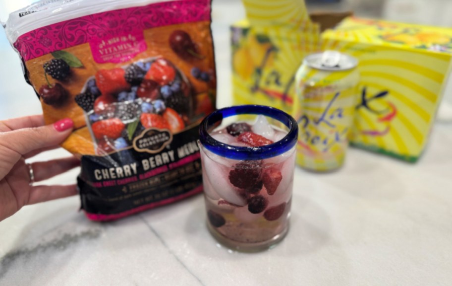adding frozen berries to sparkling water