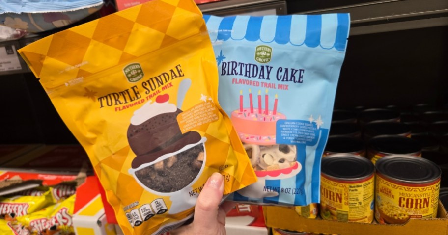 hand holding bags of candy