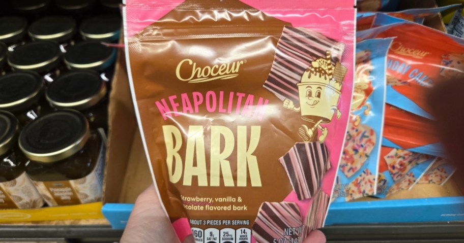 hand holding a bag of chocolate bark candy