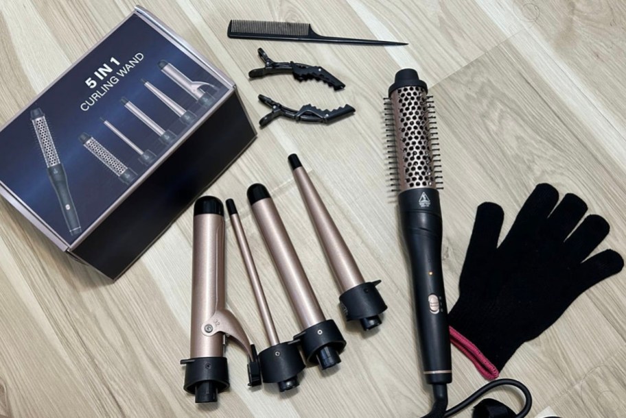 5 in 1 curling iron box on floor with wands, handle, comb, glove, and hair clips 