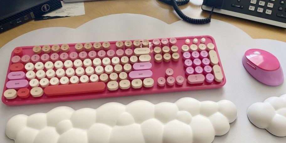 pink keyboard and mouse on computer desk 