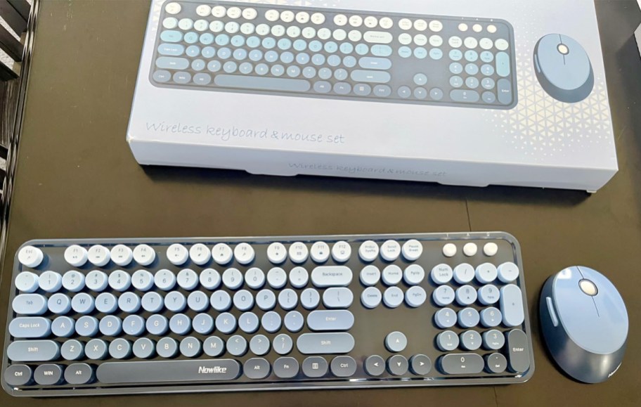 blue and black keyboard and mouse with box on table