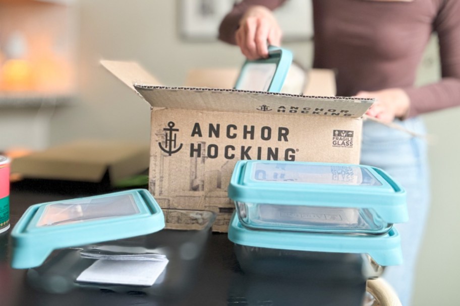 woman taking glass storage container out of box