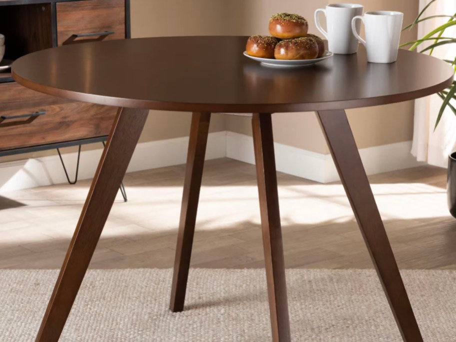 dark wood dining table with fruit on top 