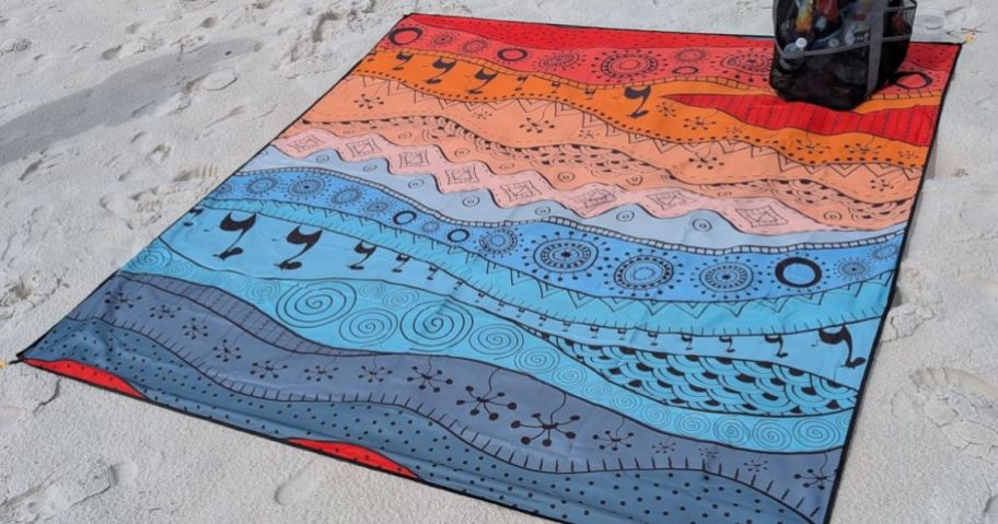 blue and orange Waterproof Beach Blanket on sand on beach