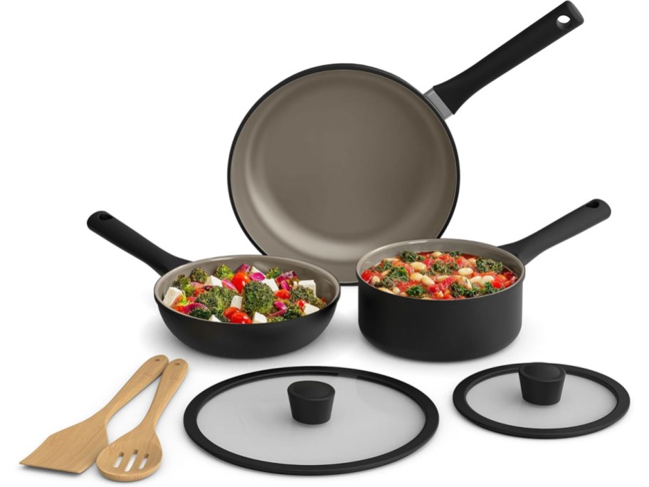 black pans, stock pot, lids, and wooden utensils