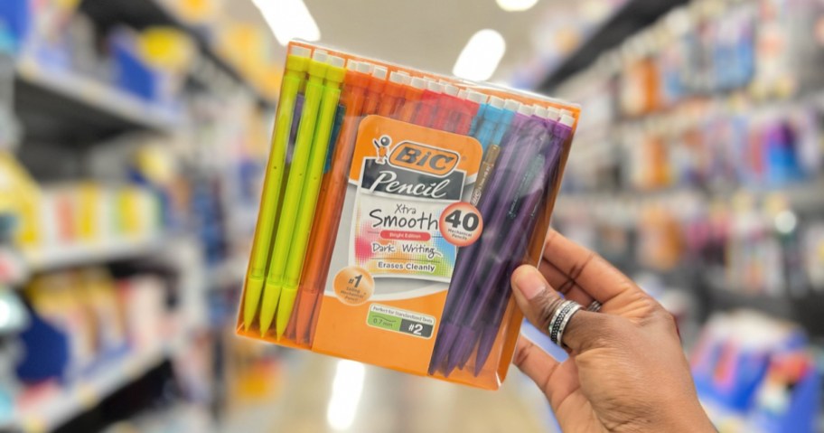 woman holding up a box of bic mechanical pencils