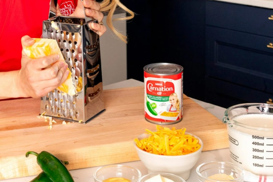 can of evaporated milk next to bowl of cheese