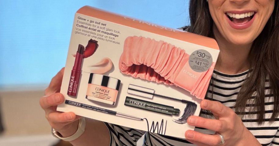 woman holding Clinique Glow + Go Skincare and Makeup 5-Piece Set box