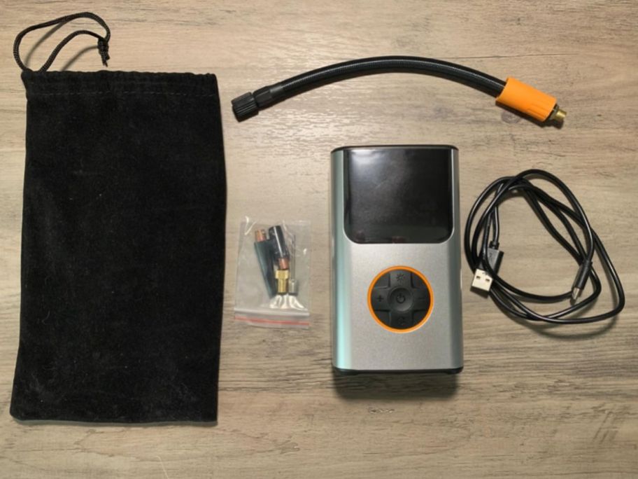 portable air compressor with bag and accessories on table