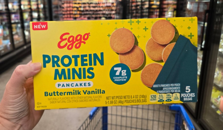 hand holding protein mini pancakes box in front of freezer