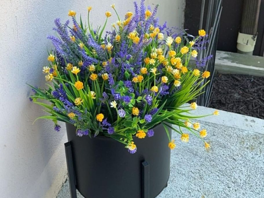 purple and yellow flowers in pot on front porch
