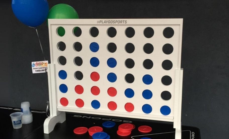 a 24 inch wooden 4 in a row game on a game table