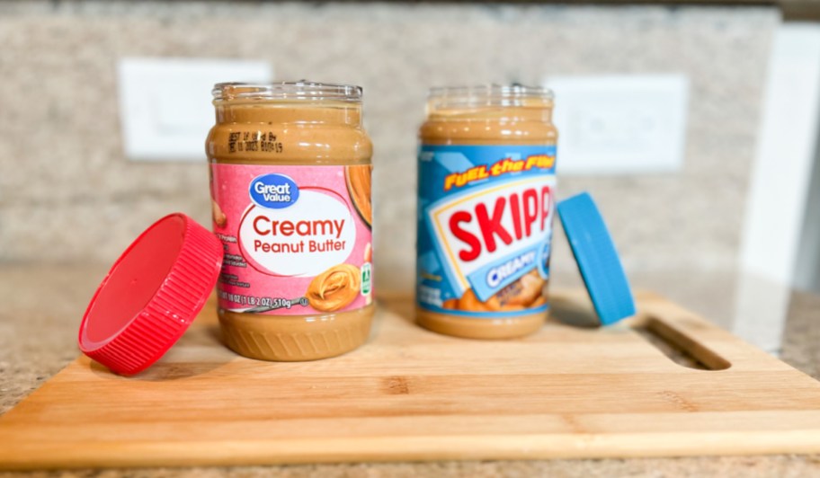 two jars of peanut butter with lids off