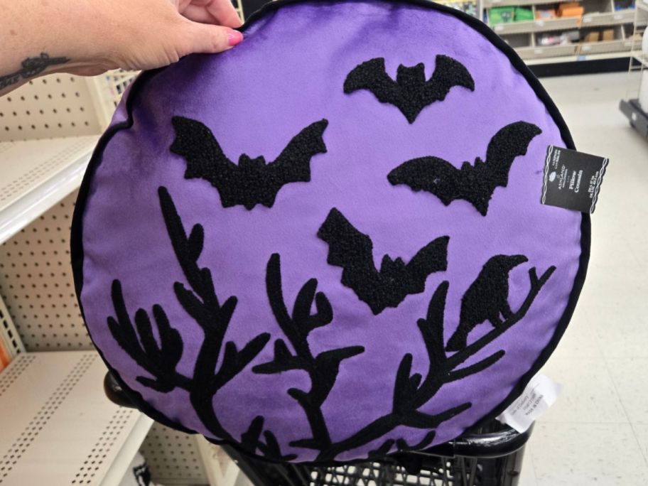 Ashland Purple Halloween Bat & Crow Tree Accent Pillow in hand in store