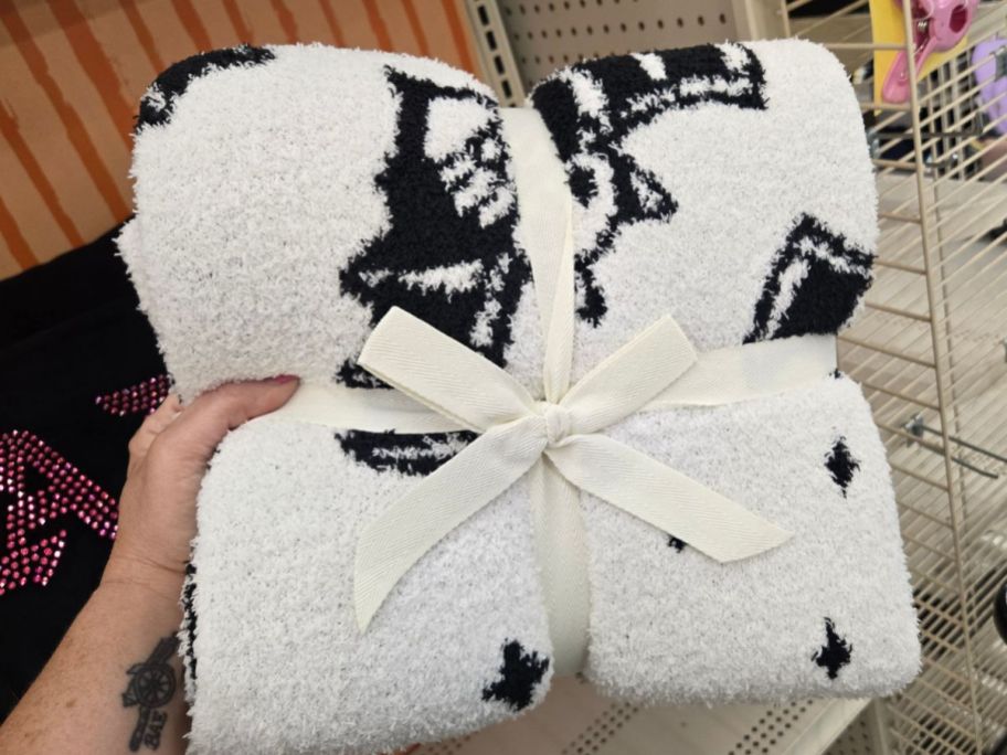 Ashland 60" Black & White Bat Throw Blanket in hand in store