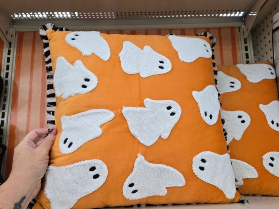 Ashland Orange Ghost Accent Pillow in hand in store