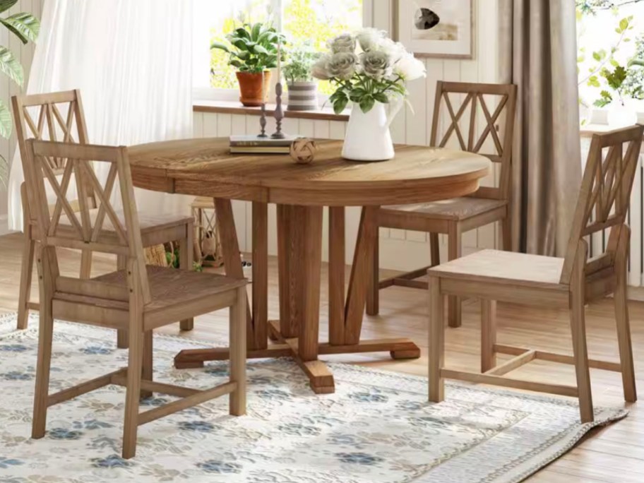 wooden table and 4 chairs with flowers on top 