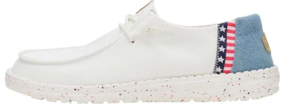 a whte sneaker with red white and blue detail on the heel