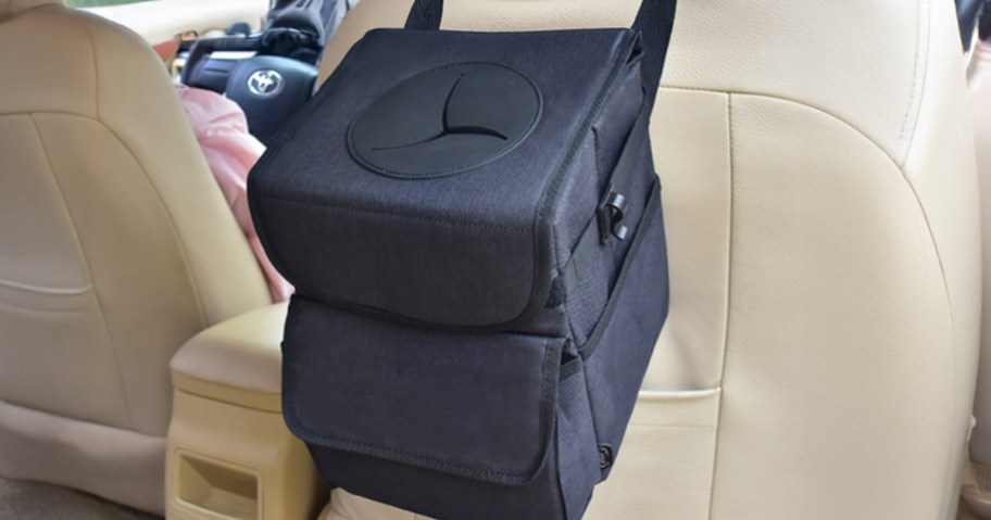 black car trash can attached to white leather seat in a car