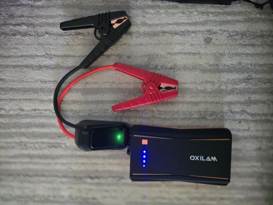 OXILAM Portable Jump Starter on table