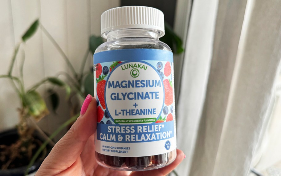 hand holding a bottle of magnesium gummies